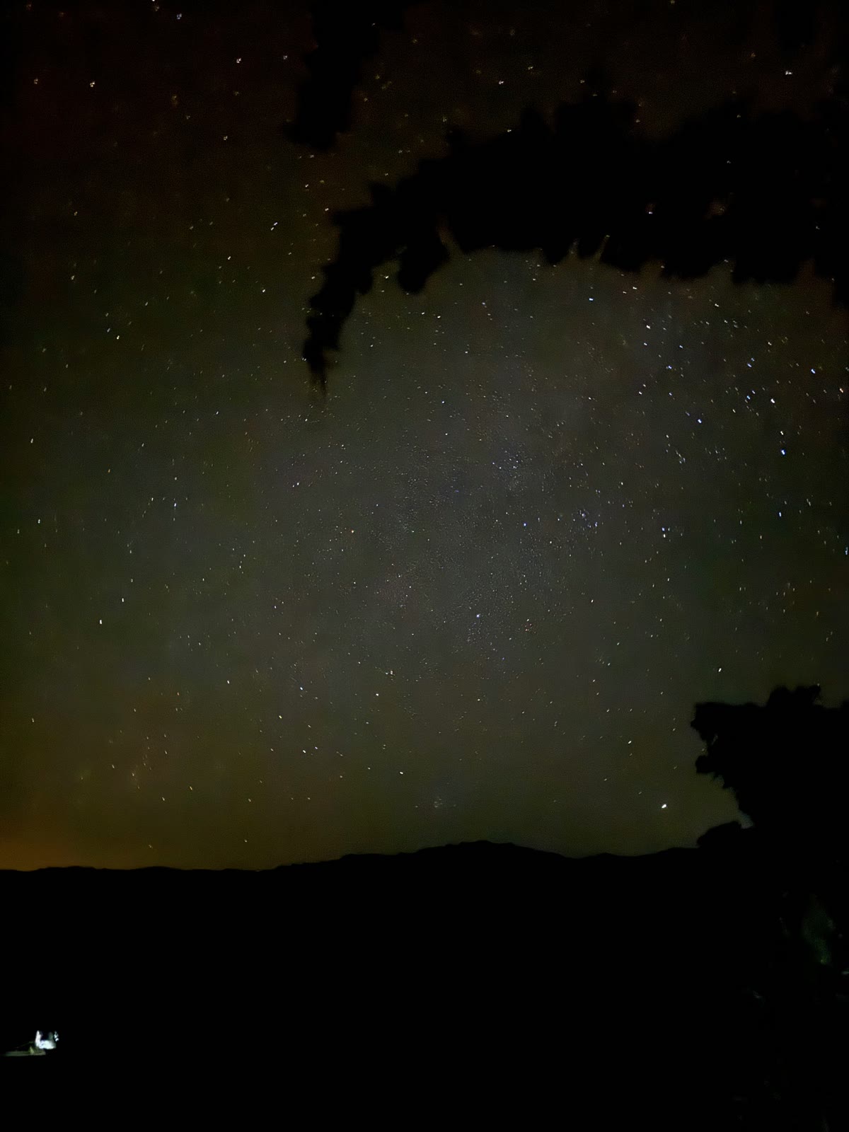 The Milky Way over the dark ridgeline above the village